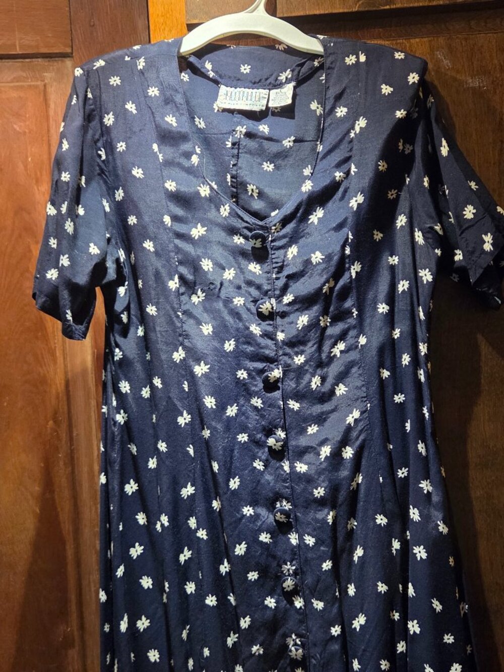Navy blue button-front dress featuring a white floral pattern